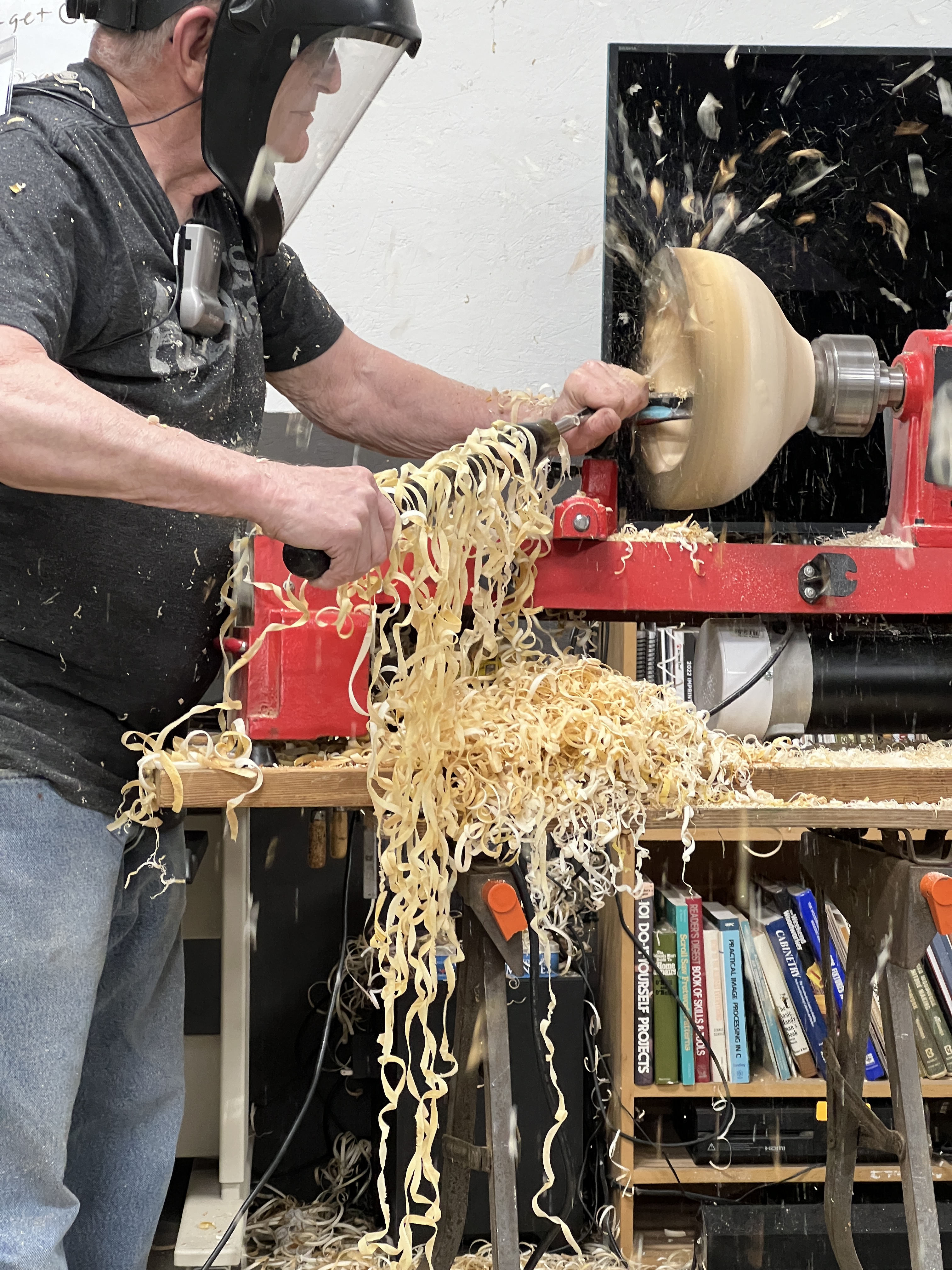 Man turning a wet live edge bowl